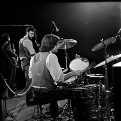 A group of men playing drums

Description automatically generated